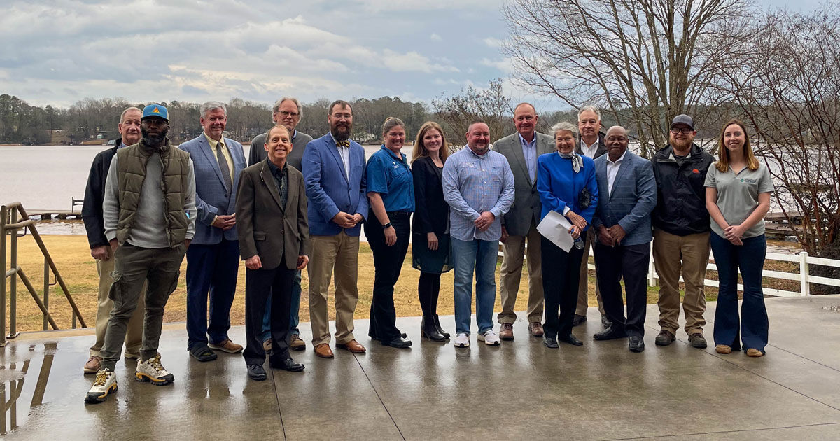 Members of the Anderson County Water Protection Council, grant recipients, and Anderson County Councilmembers celebrate the occasion at McFalls Landing on Broadway Lake. The lake is one local body of water that will be monitored by local students through grant funds.