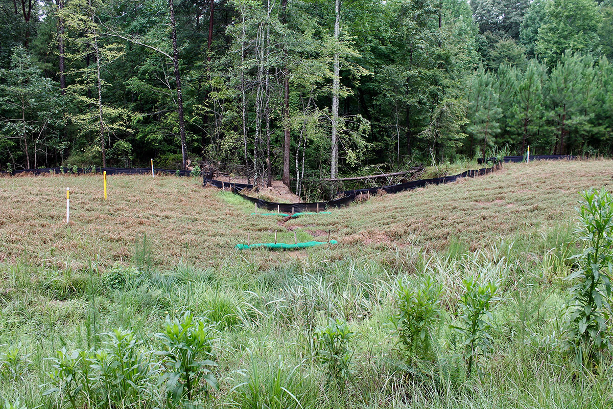 Deep gully forming beside Dominion's new high pressure natural gas pipeline in Spartanburg County. The yellow pole is the pipeline's location. Photo: Upstate Forever.