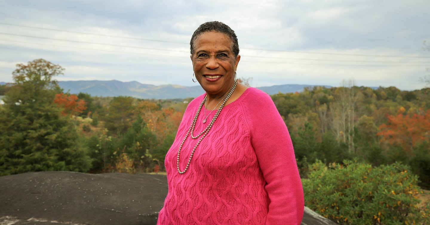 Mable Clarke stands atop one of the iconic soapstone outcroppings overlooking the Blue Ridge Escarpment in Pickens County.